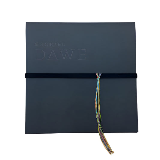 Black diploma cover with 'Gabriel Dawe' branding and a colorful tassel on a white background